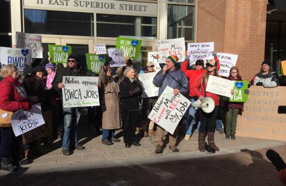 Photo of supporters holding signs at rally in Duluth