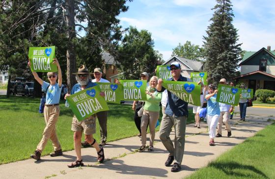 Photo of group of people walking with "We love the BWCA" sign