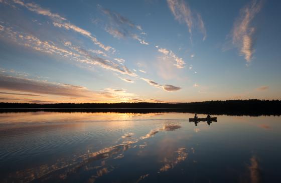 Photo credit: Steve Piragis (Photo of 2 sihlouettes paddling into sunset)