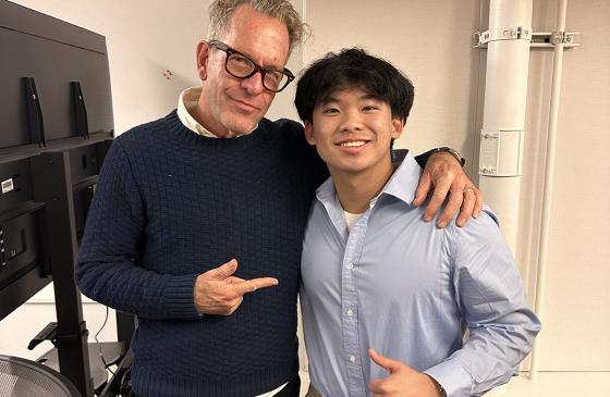 Lucas and an adult representative stand together. 