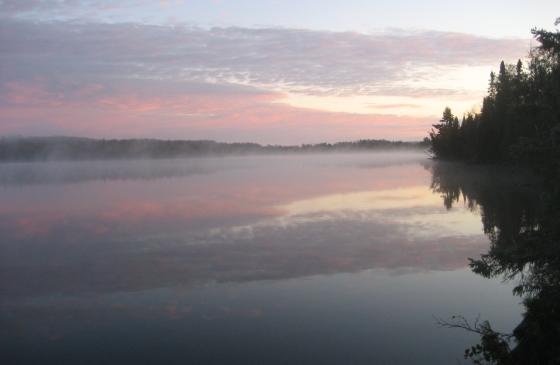 boundary waters sunset with pink and blue sky reflecting on water