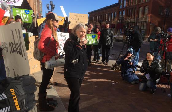 Image of Becky Rom speaking at rally in Duluth