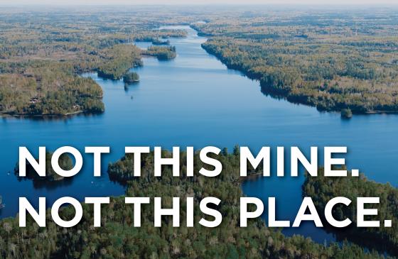 Aerial photo of the Boundary Waters with the text "Not this mine. Not this place." infront of it 