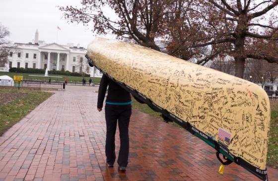 carrying signed canoe to the White House