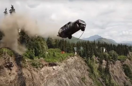 A car flies off a cliff.