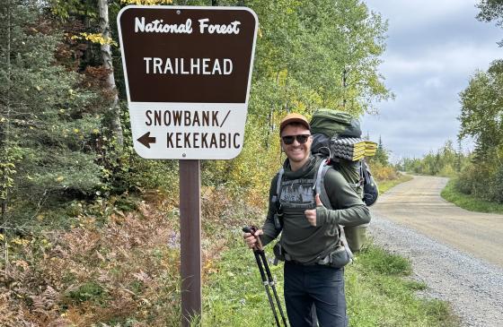 Standing at the Snowbank Lake trailhead sign. Photo: Adam Hinterland