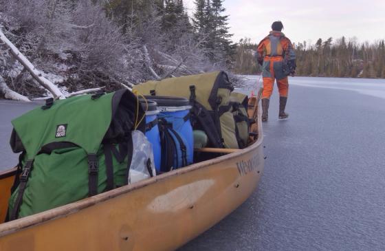 Photo of Amy Freeman pulling a canoe full of gear