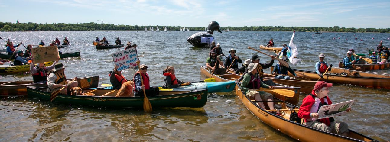 People in canoes at a flotilla