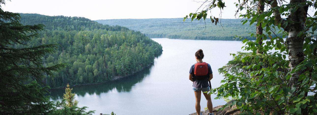 Person looking over cliff in Boundary Waters