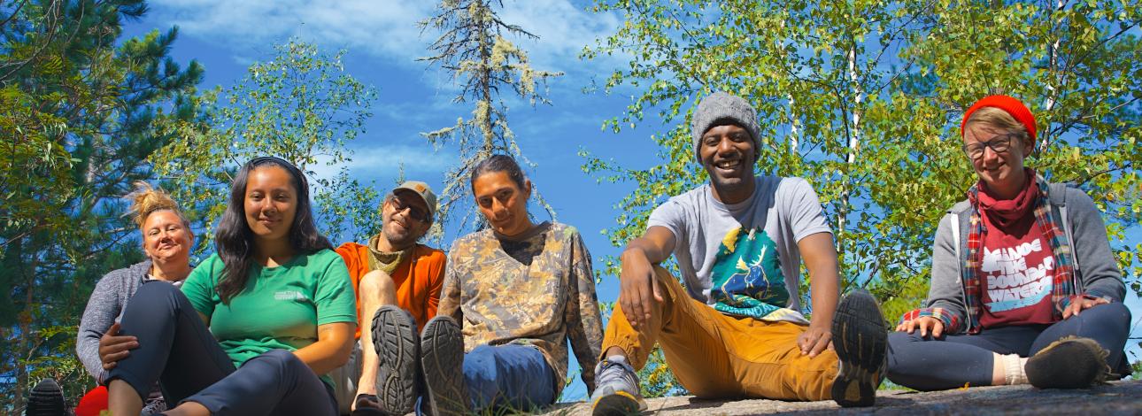 Group sitting on a rock in Boundary waters 