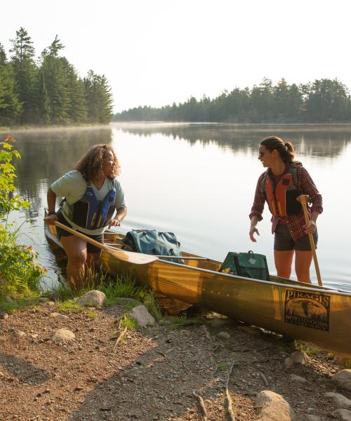 Two women by a canoe